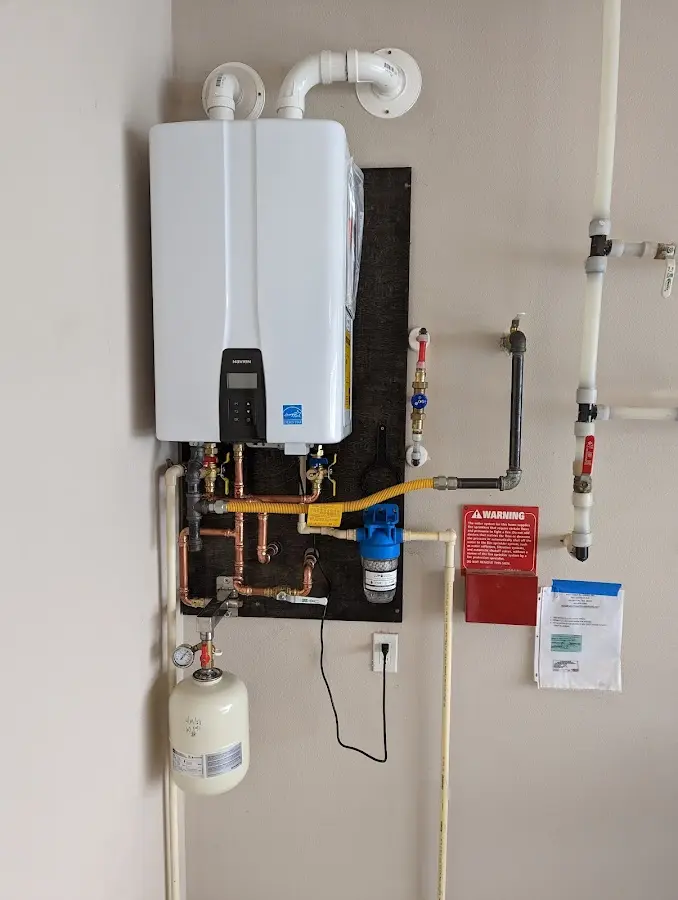 Professional plumber installing copper piping in a Milton home